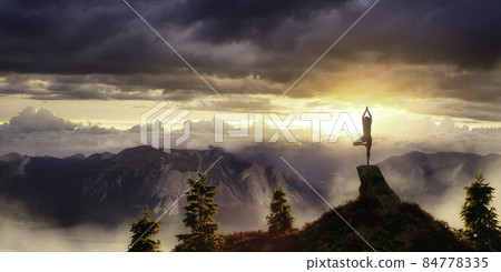 White Caucasian Adult Woman doing Yoga Pose on top of a rocky Mountain. White Caucasian Adult Woman doing Yoga Pose on top of a rocky Mountain. 84778335