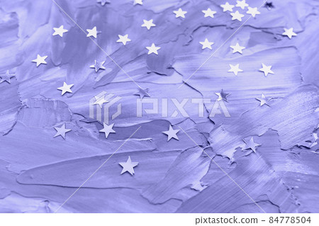 Silver foil confetti stars on blue background, toned in trendy color of the year 2022 84778504