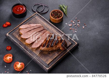 Cooked grilled Chuck eye roll steak on a chopping Board Cooked grilled Chuck eye roll steak on a chopping Board 84778526