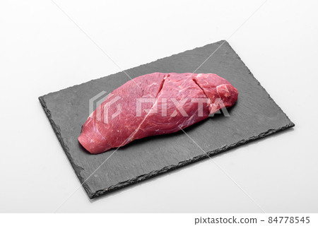 Raw fresh Chuck roll steak with herbs and salt on a cutting Board Raw fresh Chuck roll steak with herbs and salt on a cutting Board 84778545