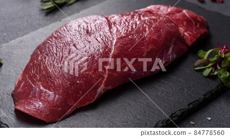 Raw fresh Chuck roll steak with herbs and salt on a cutting Board 84778560