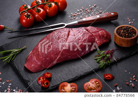 Raw fresh Chuck roll steak with herbs and salt on a cutting Board 84778566
