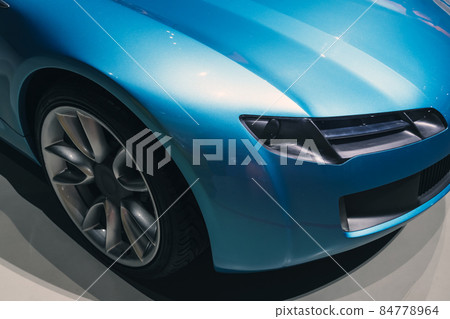 Headlight and wheel of a luxury blue roadster Headlight and wheel of a luxury blue roadster 84778964