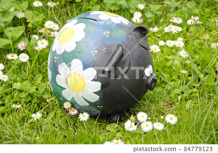ceramics piggybank on garden grass 84779123