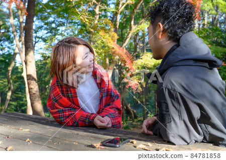 Image of couples and couples talking outdoors Image of couples and couples talking outdoors 84781858