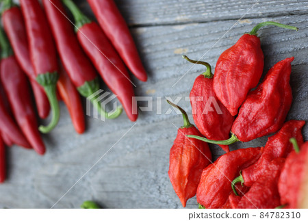 Fresh Peppers outdoors at rural farmers market, Jalapeno, Cayenne and Bhut Jolokia 84782310