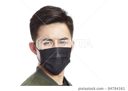 young asian man wearing black mask staring at camera, isolated on white background. 84784161