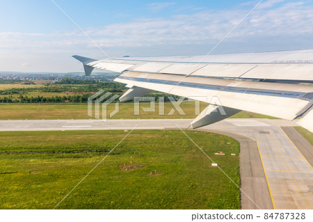 View from the airplane window during taking off on a clear summer morning. Yekaterinburg, Russia View from the airplane window during taking off on a clear summer morning. Yekaterinburg, Russia 84787328