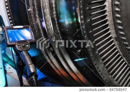 Borescope camera display on a tripod located at the turbine, Inspection of internal parts of a jet engine. Borescope camera display on a tripod located at the turbine, Inspection of internal parts of a jet engine. 84788047