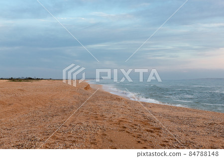Cloudy sky on the light by the sea, fishermen with fishing rods, landscape. Russia, sea of Azov, summer. 84788148