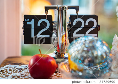 retro items in interior. black flip clock, small mirror ball and apple. 84789690
