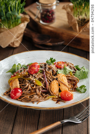 Buckwheat soba noodles with chicken wok Buckwheat soba noodles with chicken wok 84794298