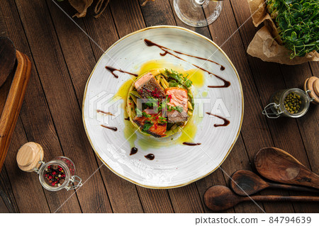 Gourmet salmon fillet on cucumbers and apple Gourmet salmon fillet on cucumbers and apple 84794639