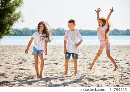 kids having fun by playing with colored powder kids having fun by playing with colored powder 84794835