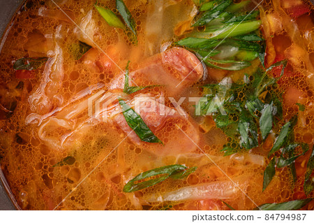 Closeup on rustic chicken noodle soup with eggs Closeup on rustic chicken noodle soup with eggs 84794987