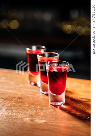 Various shot drinks on the wooden bar desk 84795116