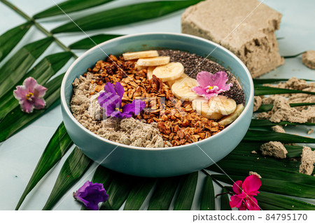 Smoothie bowl with halva bananas seeds and granola Smoothie bowl with halva bananas seeds and granola 84795170