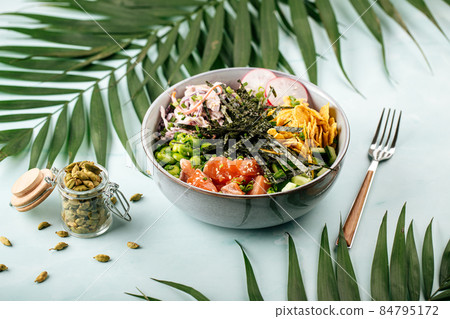 Hawaiian salmon poke bowl with rice and vegetables Hawaiian salmon poke bowl with rice and vegetables 84795172