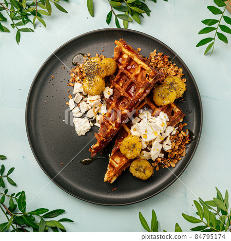 Waffles with caramelized banana and granola Waffles with caramelized banana and granola 84795174