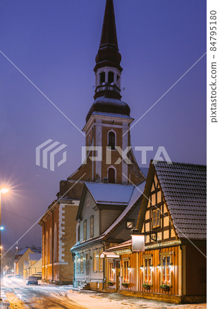 Parnu, Estonia. Night View Of Kuninga Street With Old Houses, Restaurants, Cafe, Hotels And Shops In Evening Night Illuminations. View Of Lutheran Church Of St. Elizabeth On Background Parnu, Estonia. Night View Of Kuninga Street With Old Houses, Restaurants, Cafe, Hotels And Shops In Evening Night Illuminations. View Of Lutheran Church Of St. Elizabeth On Background 84795180