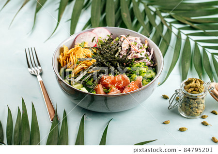 Hawaiian salmon poke bowl with rice and vegetables Hawaiian salmon poke bowl with rice and vegetables 84795201