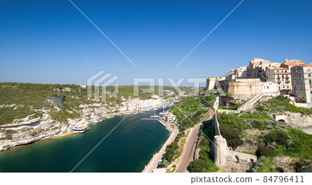 Medieval citadel of Bonifacio with harbor and blue Mediterranean sea under the ramparts 84796411
