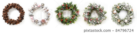 Christmas wreath of fresh natural spruce branch with red holly berries and decoration. New Year. Xmas holiday. 84796724