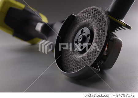Angle pneumatic grinders grinder with a disc on a gray background Angle pneumatic grinders grinder with a disc on a gray background 84797172