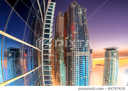 Dubai Marina with skyscrapers against colorful sunrise in Dubai, United Arab Emirates Dubai Marina with skyscrapers against colorful sunrise in Dubai, United Arab Emirates 84797429