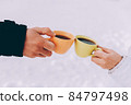 Two cups of coffee in the hands of happy couple. Winter theme 84797498