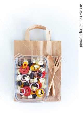 Lunch box with greek salad on the craft paper bag Lunch box with greek salad on the craft paper bag 84798346