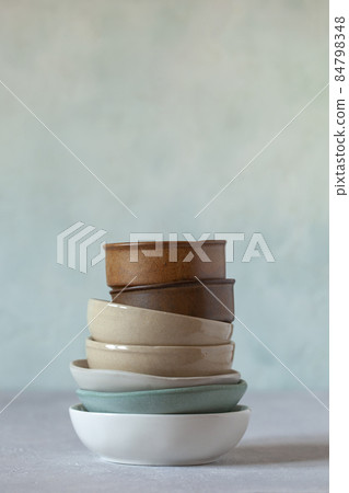 Small bowls of natural colors on the light green background 84798348