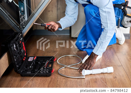 Cropped Handyman Of Afro American Appearance In Blue Overalls Repairing 84798412