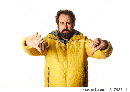 bearded man looking sad, disappointed or angry, showing thumbs down in disagreement, feeling frustrated. bearded man looking sad, disappointed or angry, showing thumbs down in disagreement, feeling frustrated. 84798744