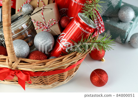 Odessa, Ukraine - November 10, 2021: Concept of gift with Christmas basket on white background Odessa, Ukraine - November 10, 2021: Concept of gift with Christmas basket on white background 84800051
