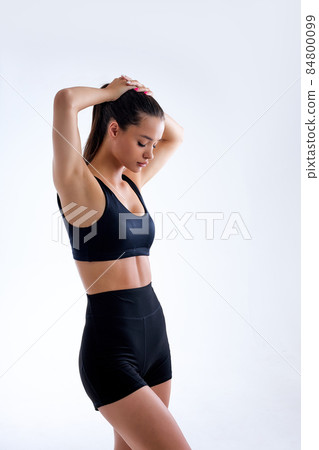 side view on muscular young fit woman posing in sportswear against white background side view on muscular young fit woman posing in sportswear against white background 84800099