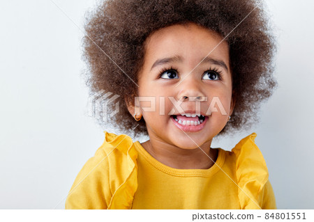 Cheerful little african girl isolated on white studio background, having fun Cheerful little african girl isolated on white studio background, having fun 84801551