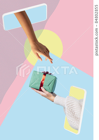 Female hands sticking out tablet screen and exchange gifts isolated over light background. Holidays concept 84802855