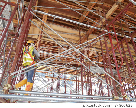 JOHOR, MALAYSIA -APRIL 13, 2016: Scaffolding used as the temporary structure to support platform, form work and structure at the construction site. Also used it as a walking platform for workers.  84803623