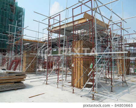 MALACCA, MALAYSIA -APRIL 26, 2016: Column form work made from timber and plywood fabricated at the construction site by workers. MALACCA, MALAYSIA -APRIL 26, 2016: Column form work made from timber and plywood fabricated at the construction site by workers. 84803663
