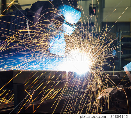 Industrial Worker at the factory welding 84804145