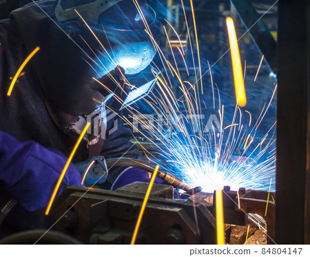 Industrial Worker at the factory welding Industrial Worker at the factory welding 84804147