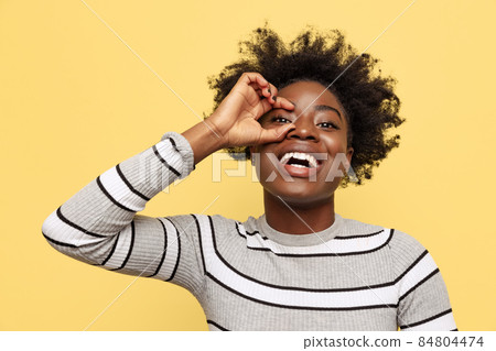 Emotional African young girl in casual clothes having fun isolated on dark green studio background. Concept of emotions, facial expressions Emotional African young girl in casual clothes having fun isolated on dark green studio background. Concept of emotions, facial expressions 84804474