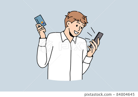 Happy young man shopping on cellphone with credit card Happy young man shopping on cellphone with credit card 84804645