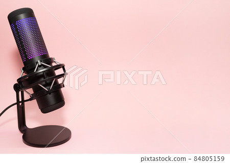 Microphone with place for text on a pink background. Copy space. Modern, backlit microphone. Concept for podcast, stream, blogger, and broadcast. 84805159