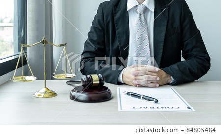 Male lawyer working with legal case document contract in office 84805484