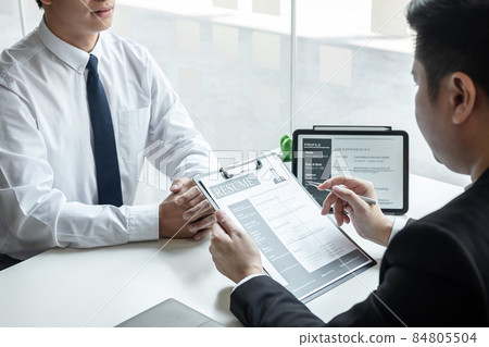 Businessman interview consider a resume conversation during about profile of candidate of conducting a job interview listen to answers while sitting at the working meeting in office Businessman interview consider a resume conversation during about profile of candidate of conducting a job interview listen to answers while sitting at the working meeting in office 84805504