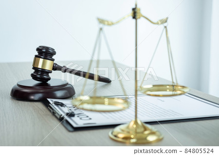 Judge gavel with Justice at law firm in background with legal case document contract, law and justice, attorney, lawsuit 84805524