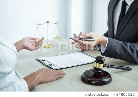 Professional Male lawyer or counselor discussing negotiation legal case with client meeting with document contract in office, law and justice, attorney, lawsuit concept 84805528
