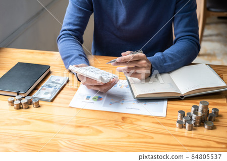 Young man and pile coins to planning growing saving strategy with pile coins for future plan fund of travel, education, home and retirement 84805537